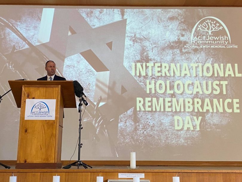 man presenting on stage for International Holocaust Remembrance Day