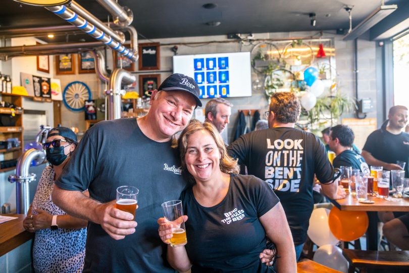 man and woman embracing holding beer