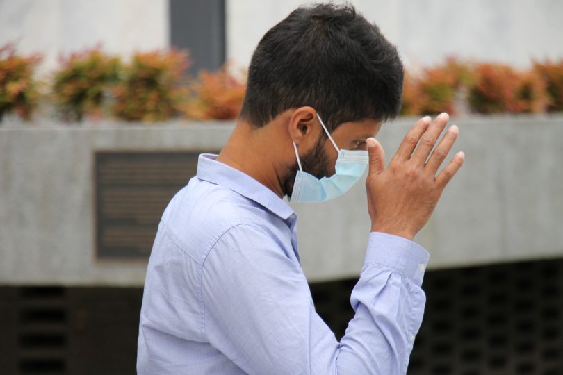 Man leaving court covering his face