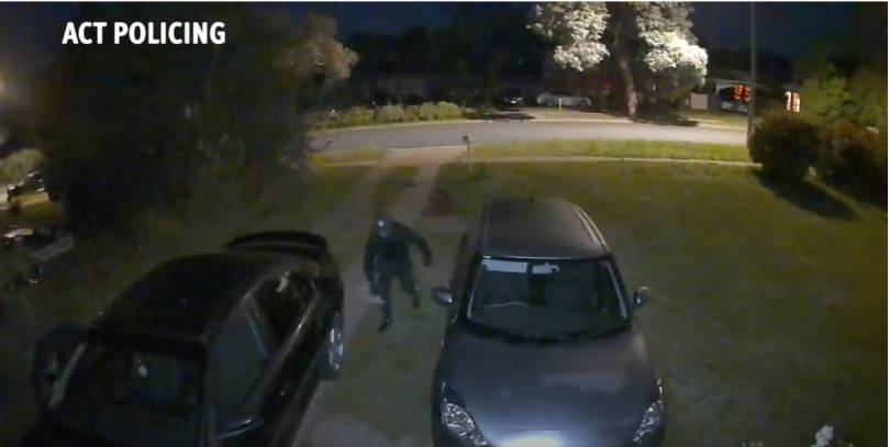 Screenshot of suspicious men in driveway of Rivett home