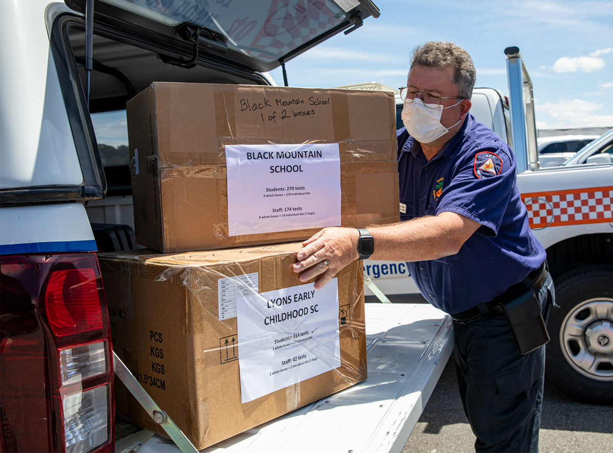 COVID tests being packed into the back of a car