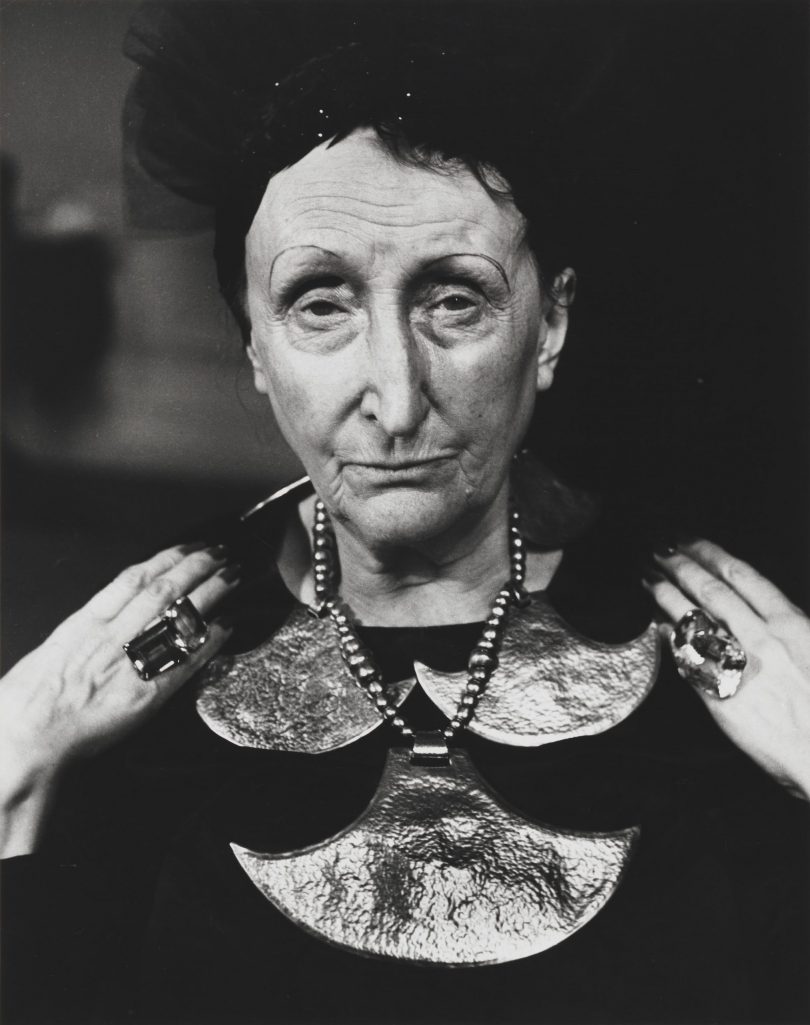 black and white photo of a lady with large jewellery pieces