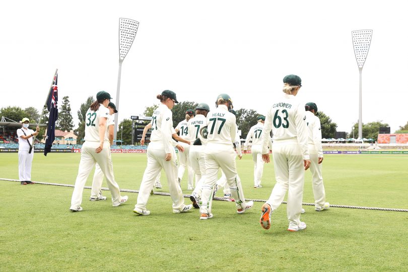 The Australian women's cricket team takes the field at Manuka Oval. 