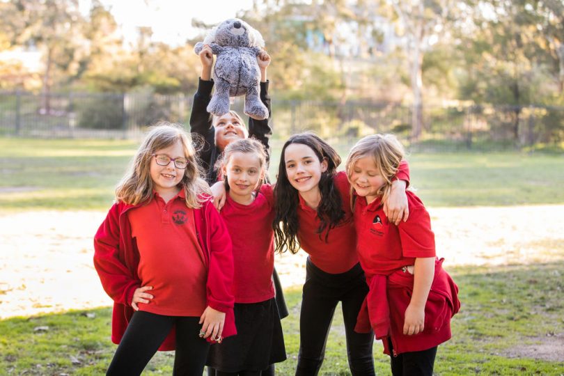 Children in school uniform smiling