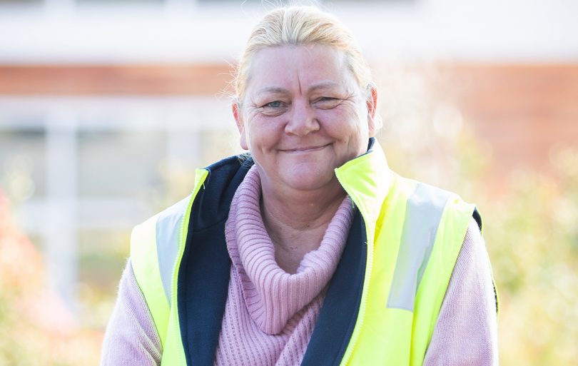 Smiling woman in high visibility vest