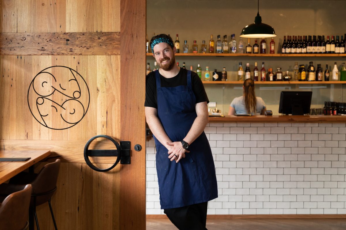 chef leaning on door