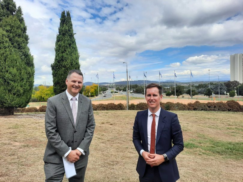 Two men standing on grass