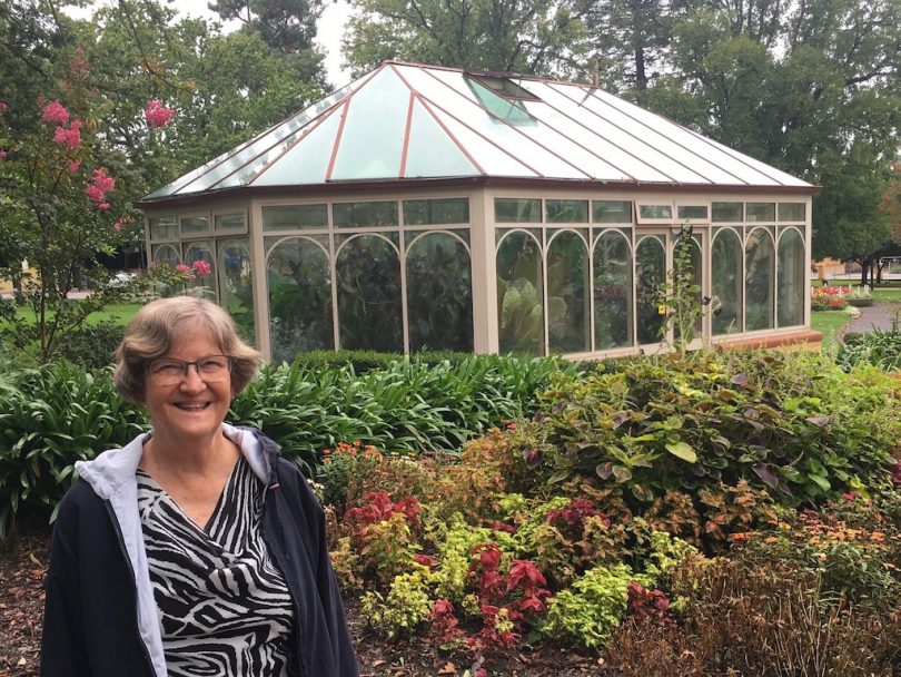 Women in front of a glasshouse