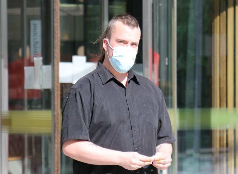 Man leaving court wearing a mask