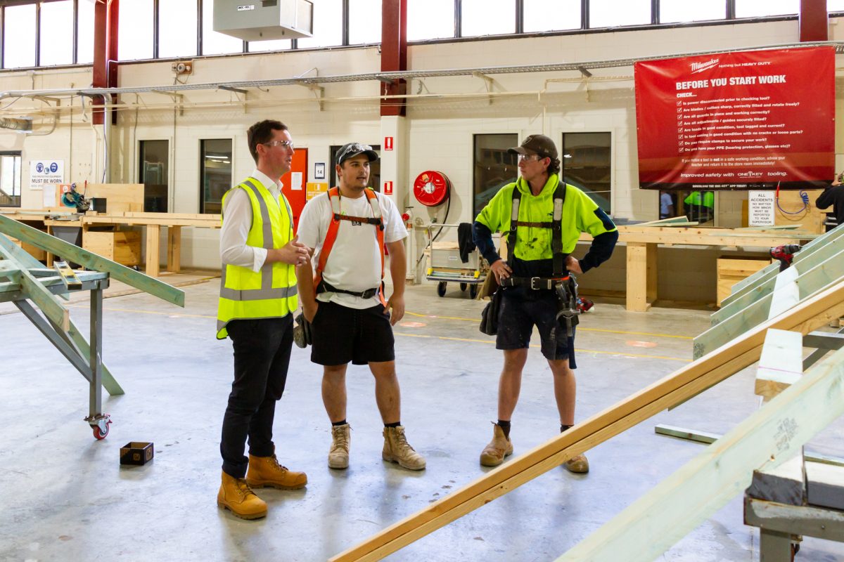 Chris Steel speaks with two carpentry apprentices at CIT Bruce