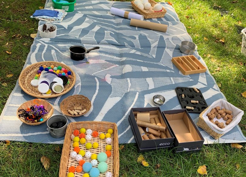 rug on grass and sensory play items