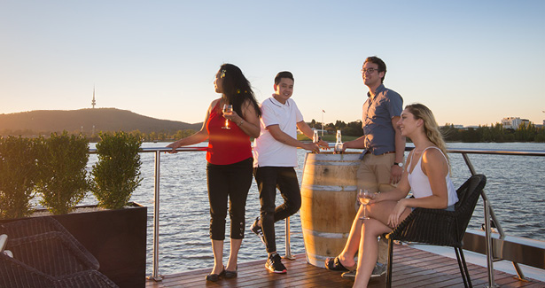 people standing on a deck overlooking the lake