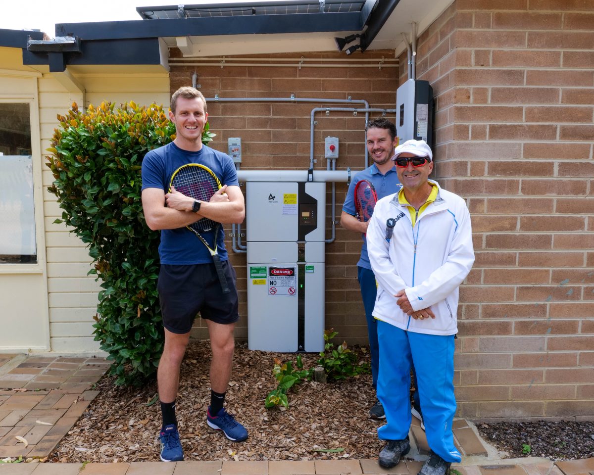 Three men with solar battery storage gear