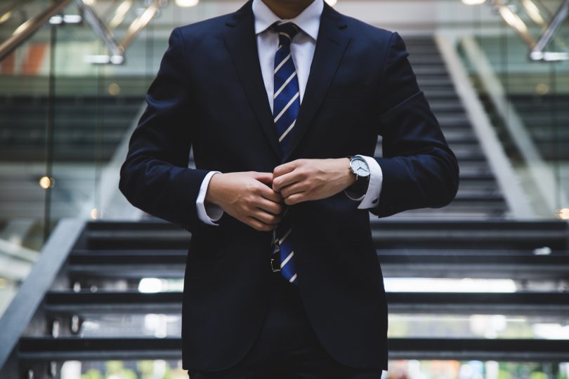 Man buttoning blazer