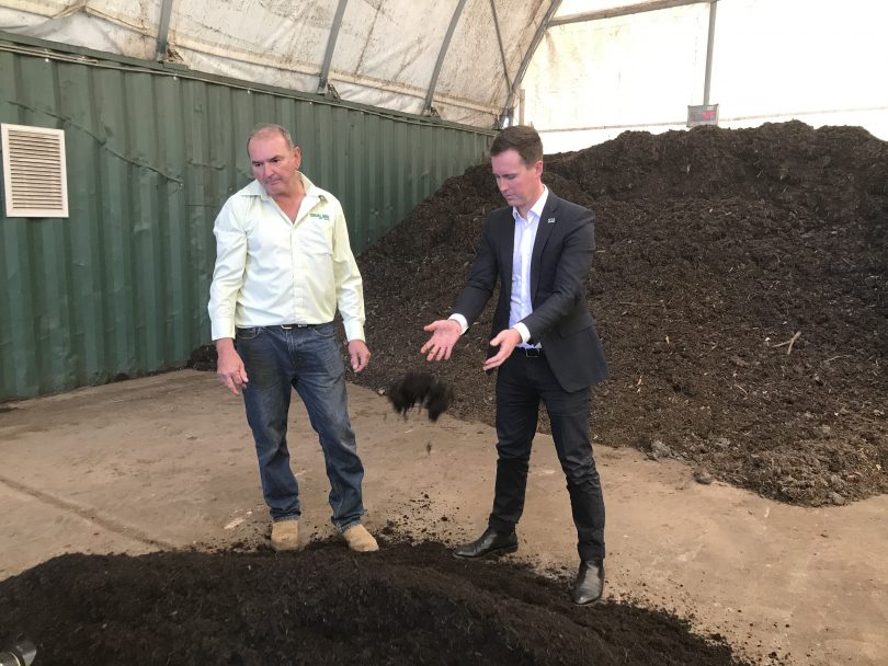 Phil corkhill and Chris Steel look at a pile o compost