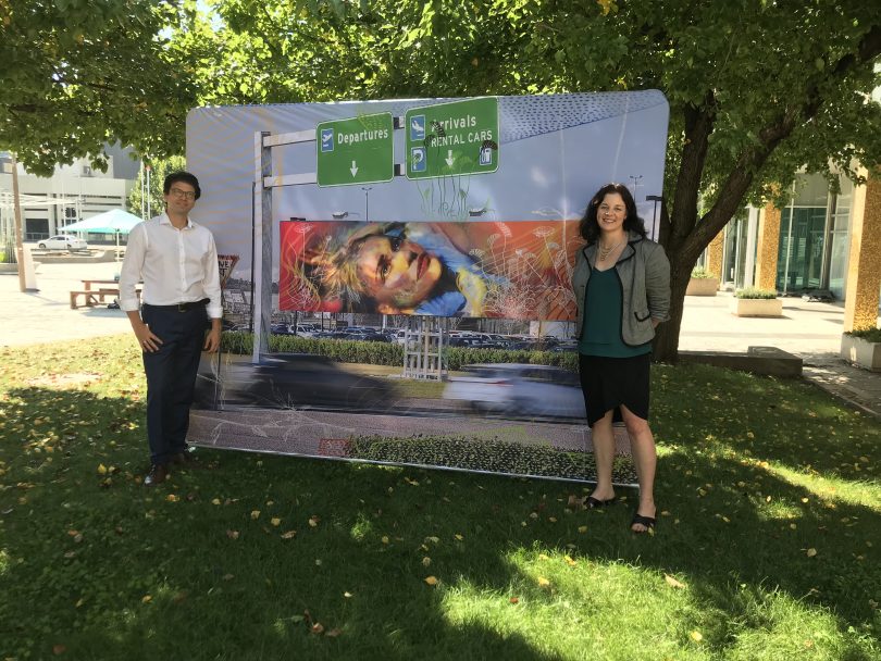 Tim Hollo and Jo Clay standing in front of street art