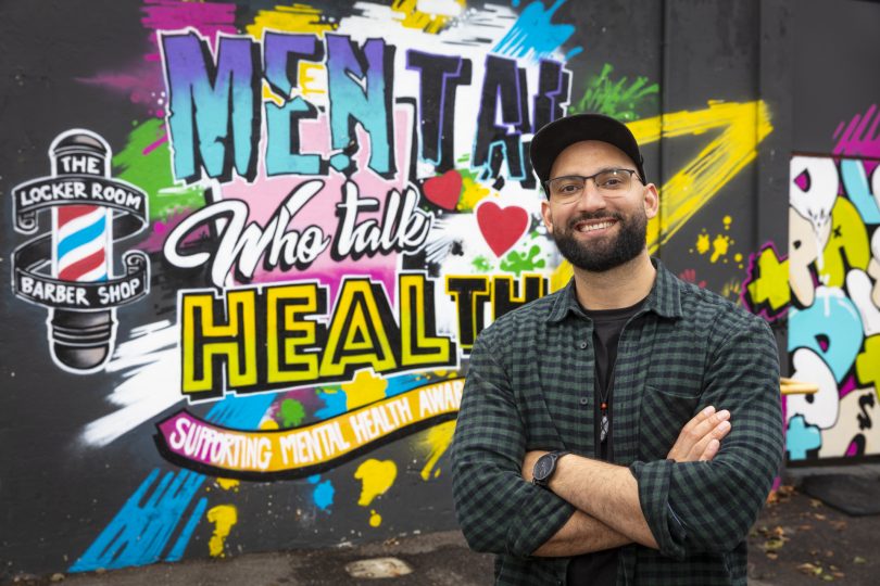 Man in front of company sign