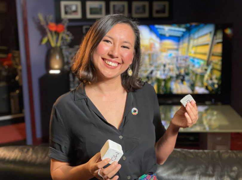 Smiling woman holding carbon blocks