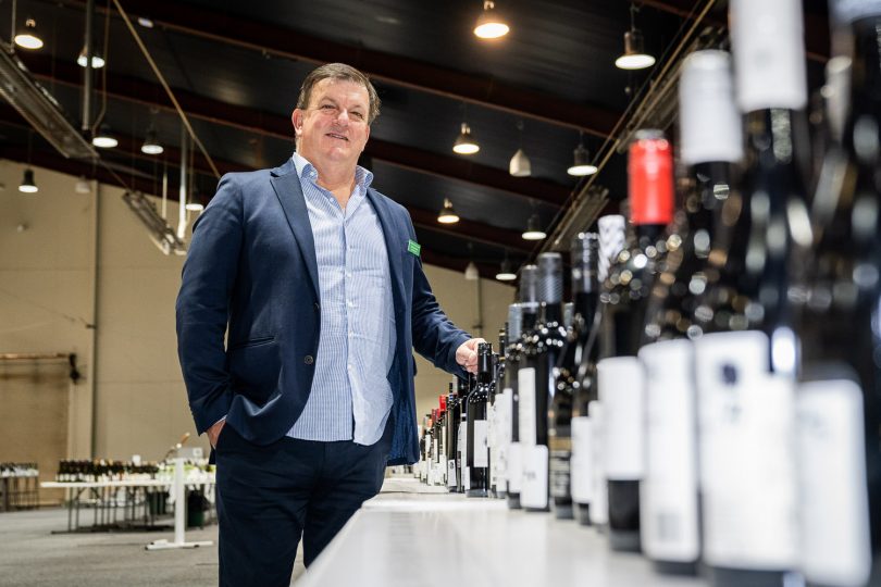 Man next to bottles of wine