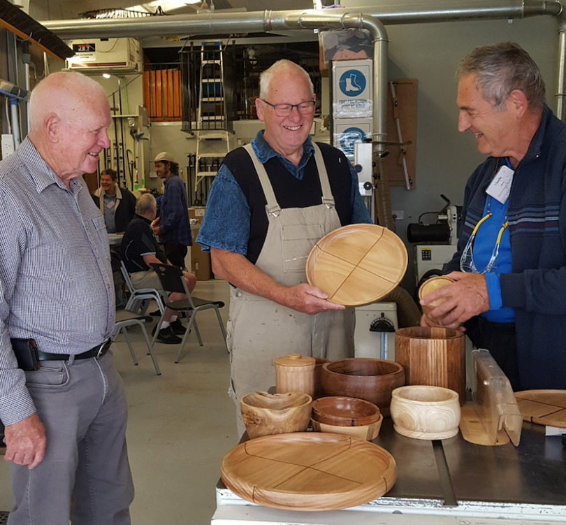 Belconnen Men's Shed members show off some of their woodwork projects.