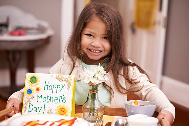 Child with breakfast for mum