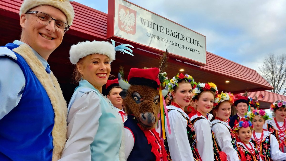 people in traditional polish costumes standing out the front of the Polish Club