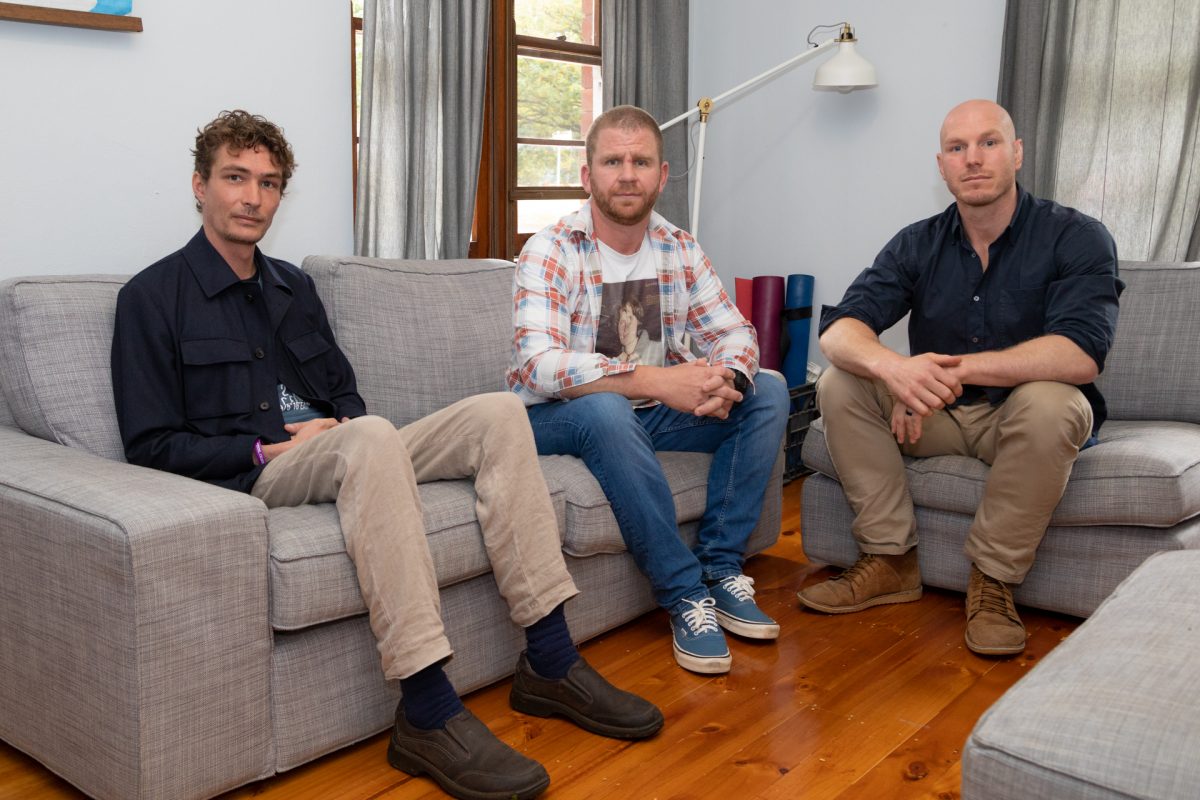 Three men sitting in a lounge room