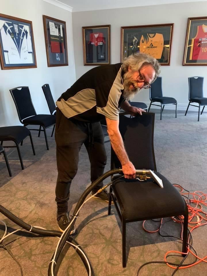 Staff member Gordon steam cleaning chairs at Wagga RSL