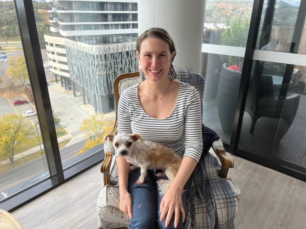 Irene Christis with her dog on her lap.