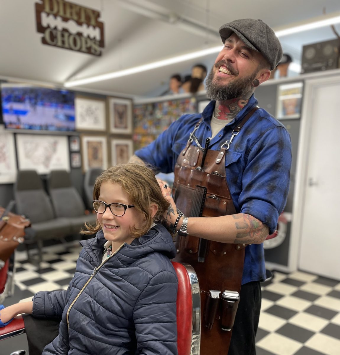 Dave Edwards styles his daughter Matilda's hair in the barber's chair at Dirty Chops.. 