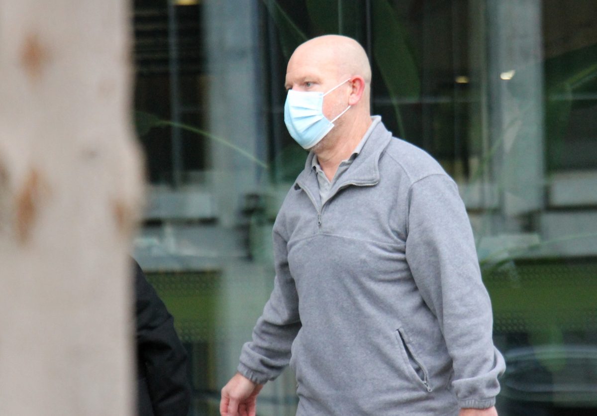 Man in mask leaving court