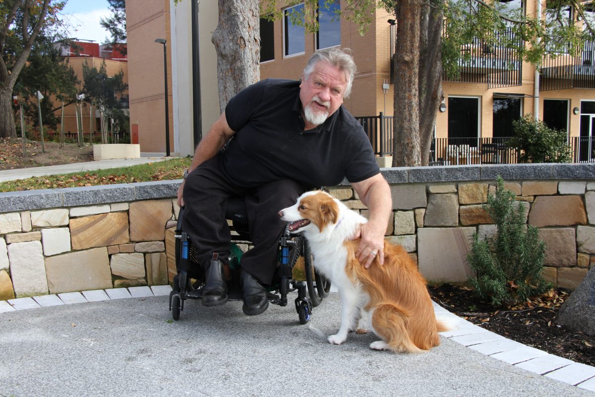 Andrew Rambow in his wheelchair with border-collie Rosy at his side.