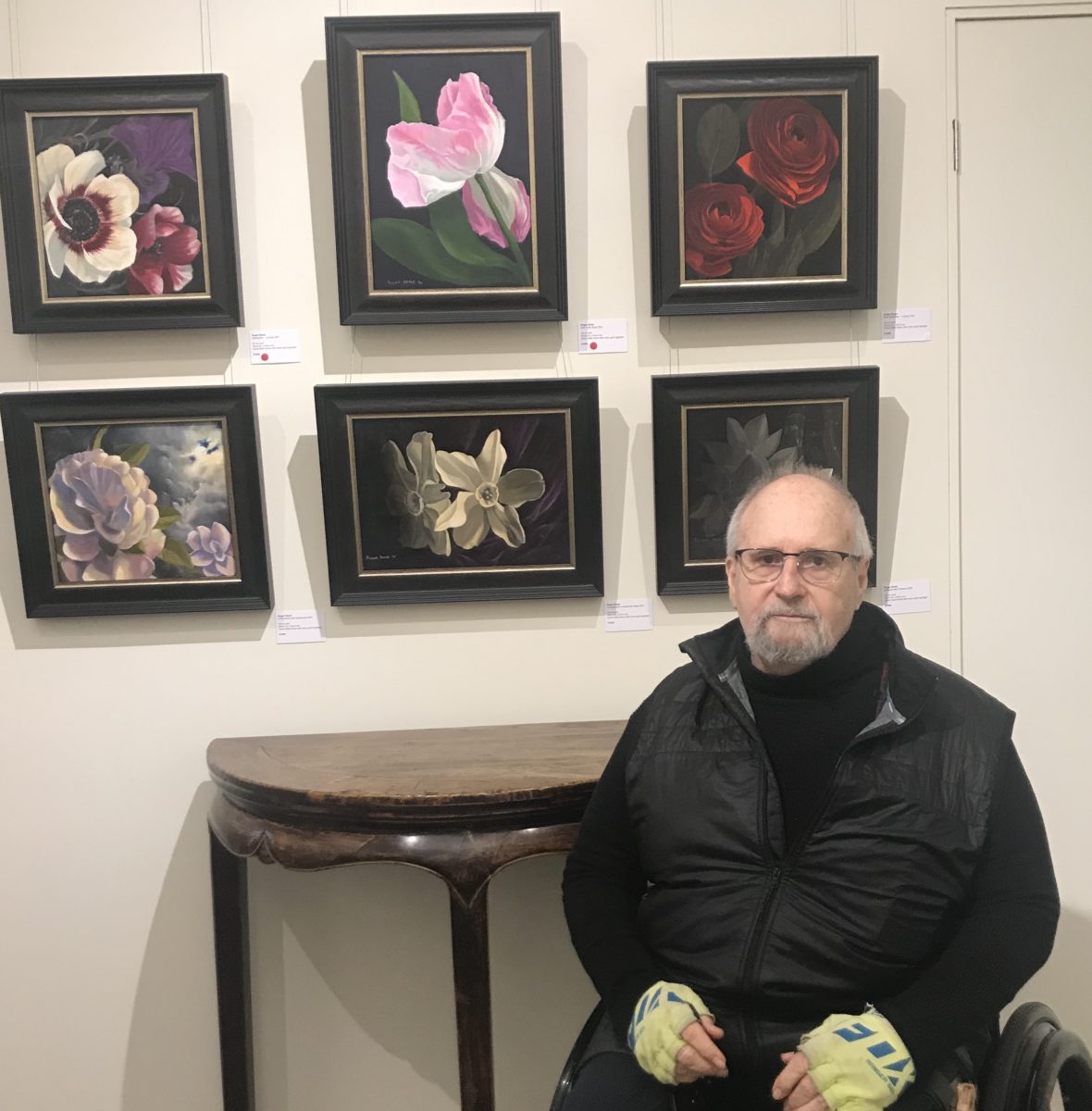 Man in wheelchair with paintings