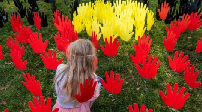 Paper hands in grass