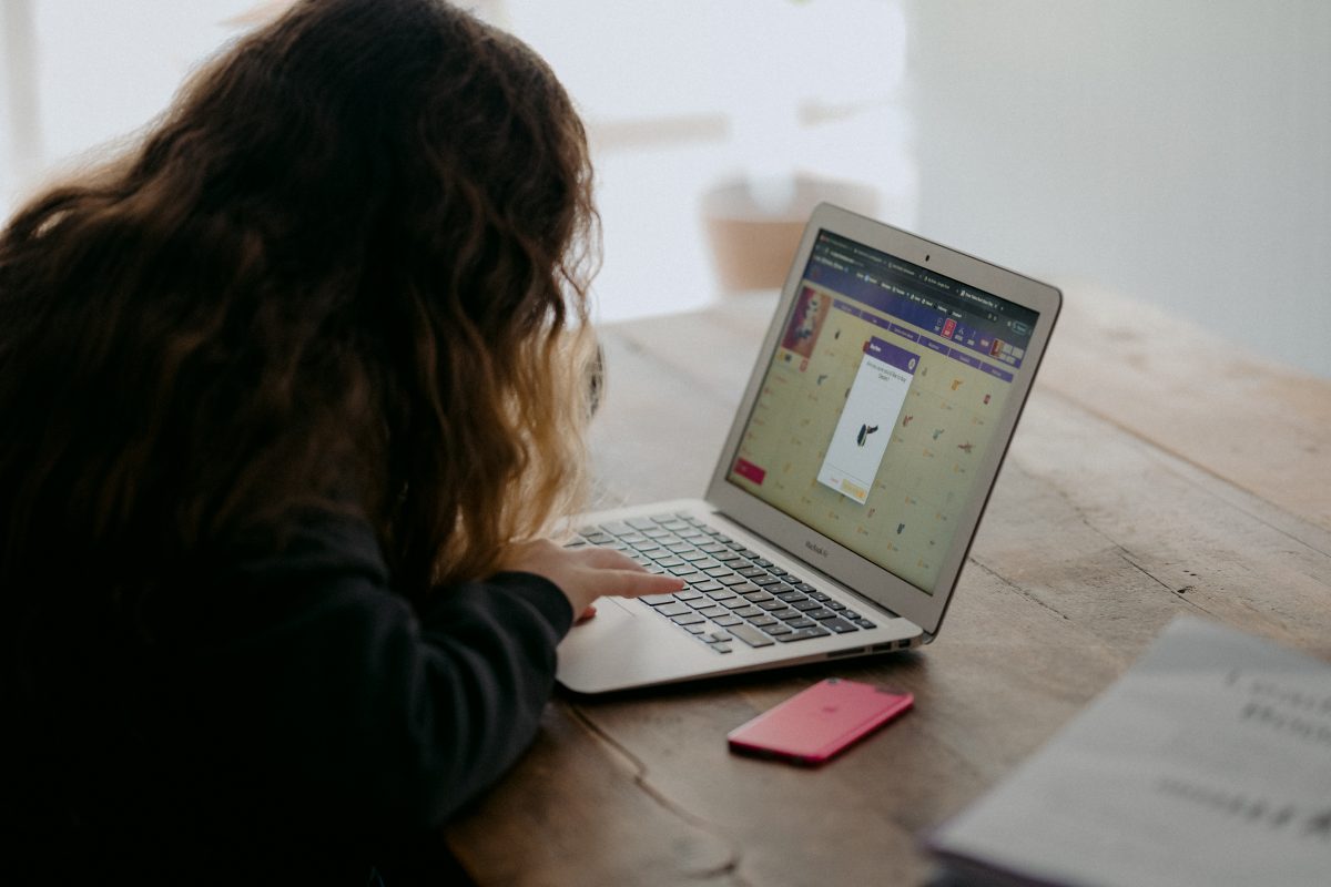 A girl operates her laptop.