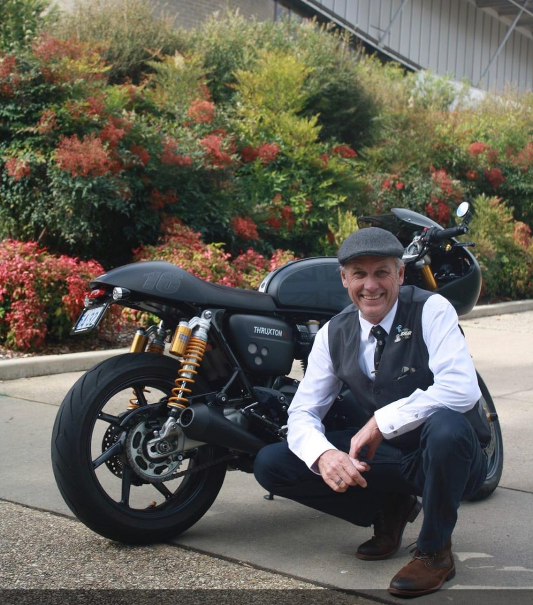 Simon Whitaker crouched near his bike for The Distinguished Gentleman's Ride