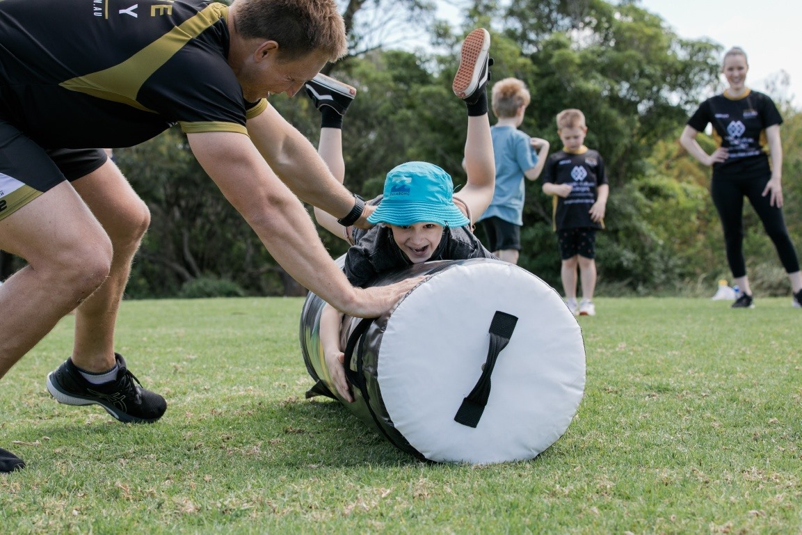 Young boy does exercises during Sense Rugby training