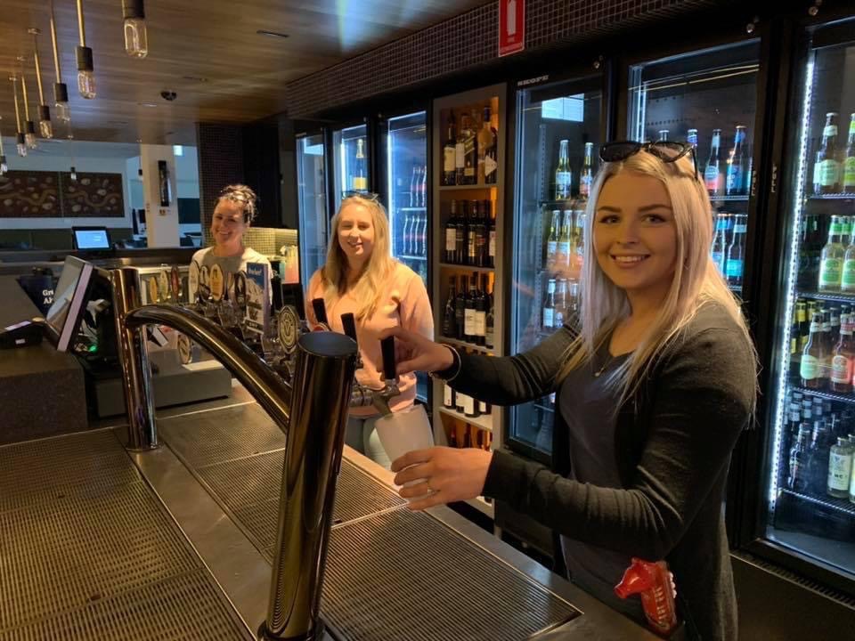 Three bartenders behind the bar at Wagga RSL