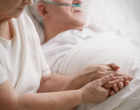 Elderly person in hospital bed