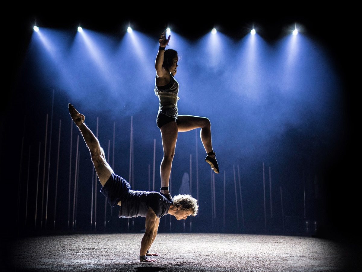 Circus performers balancing on each other