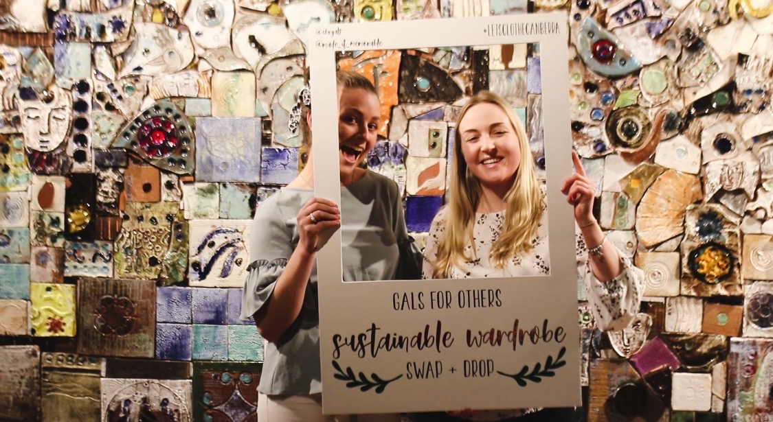 Two women holding social media frame