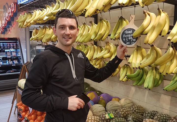 Man in front of bananas