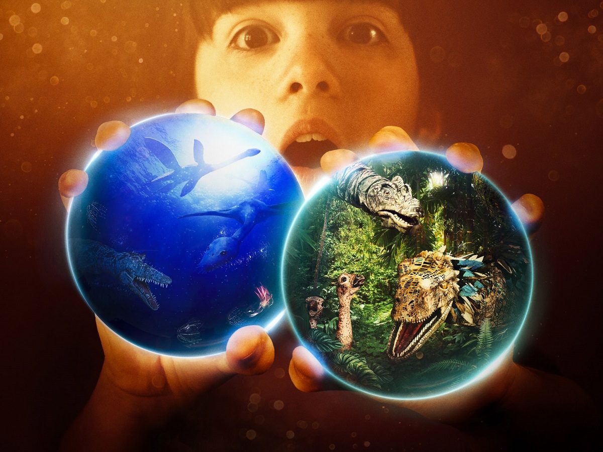 Boy holding the world and prehistoric animals in each hand