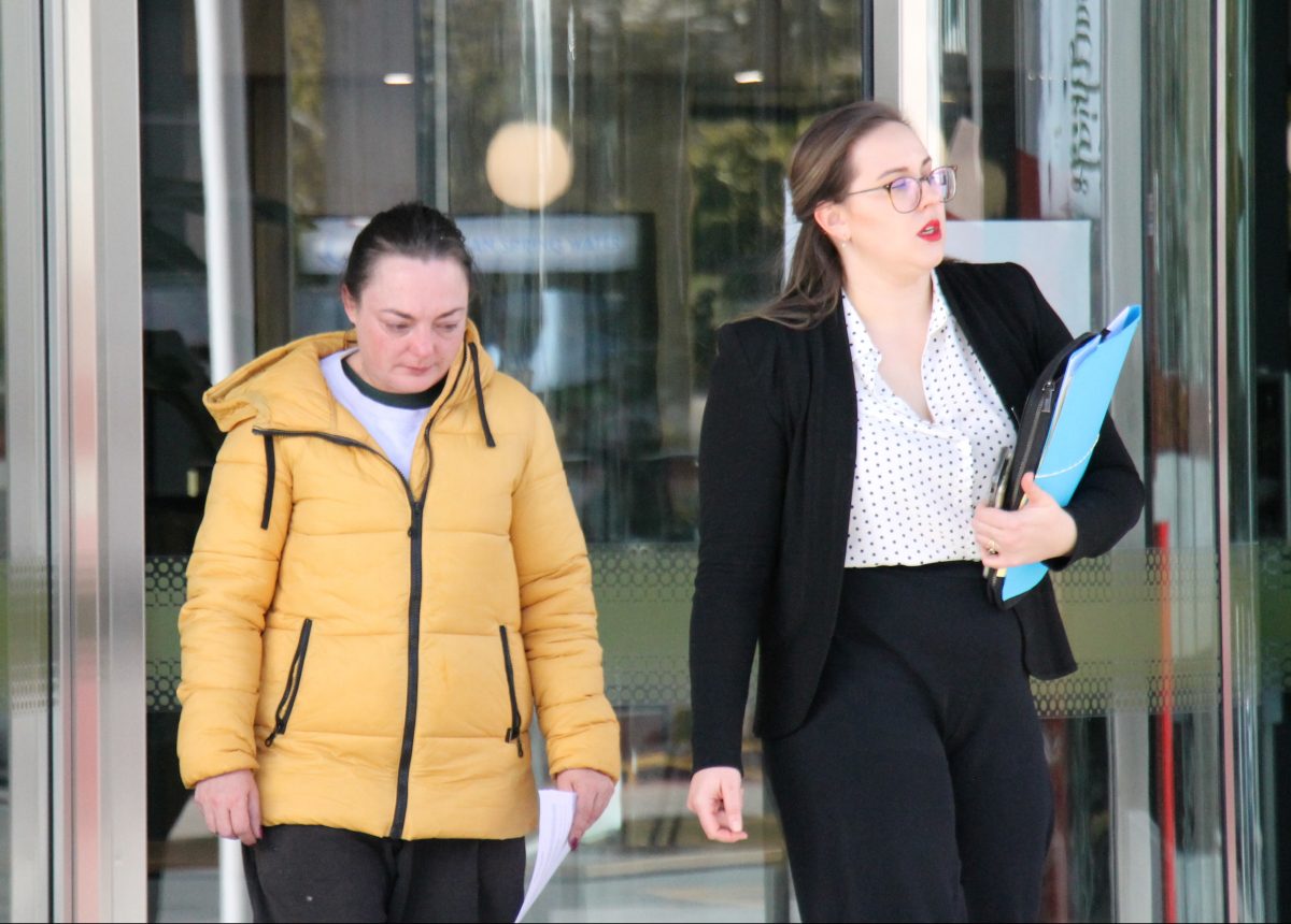 Two women leaving court