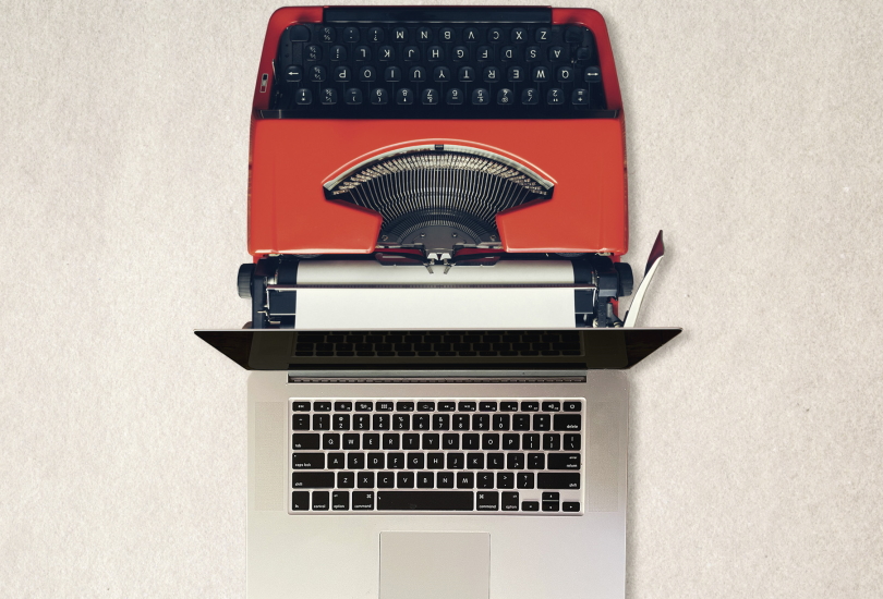 typewriter next to a laptop