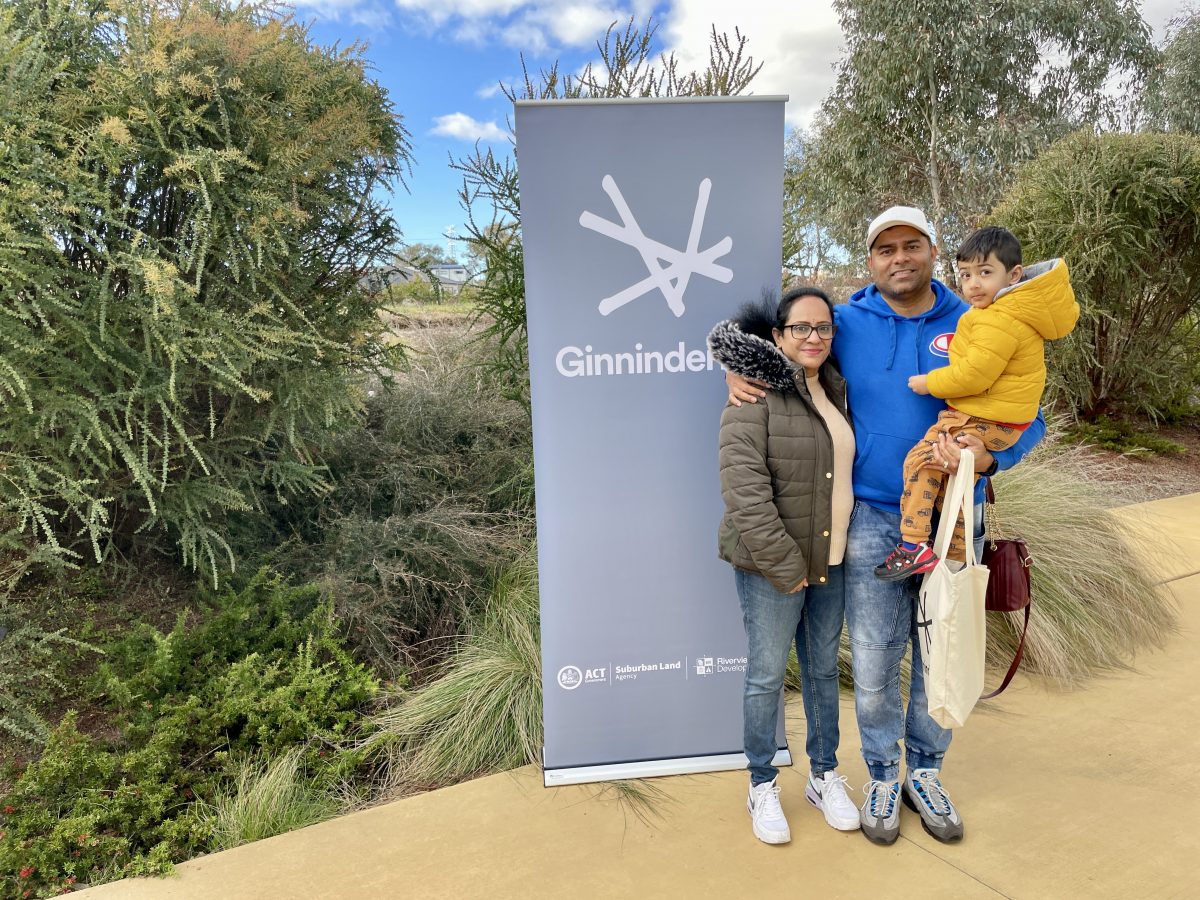 Family next to sign