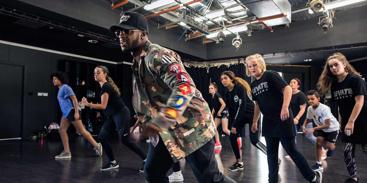 Dance teacher leads young dancers in choreography