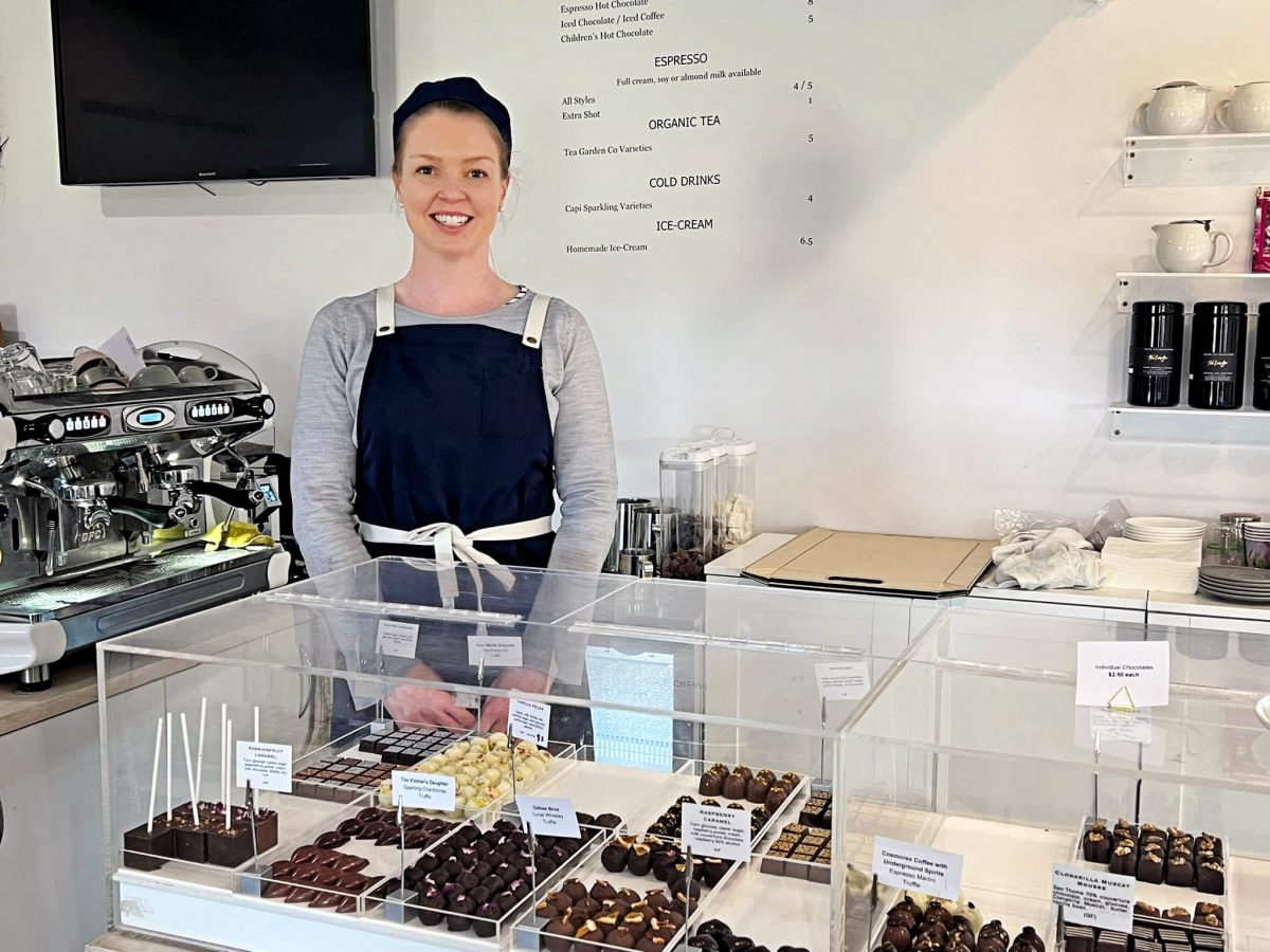 Woman standing behind chocolates