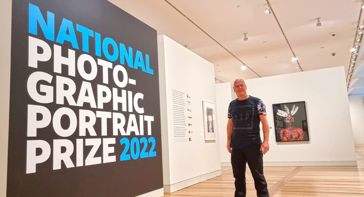 Man in front of sign