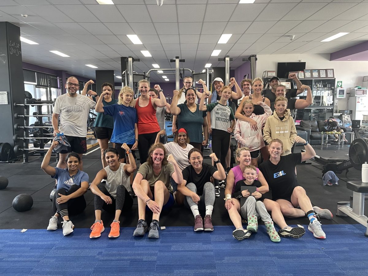 large group of people in a gym post workout